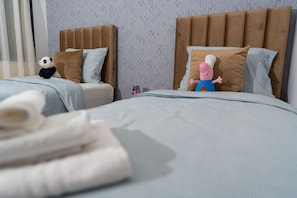 A hotel room with two beds, each with a headboard, pillows, and a blanket. - Amazing 3-bedroom apartment with AC in charming Tangier (Tangier)