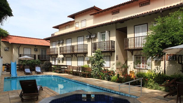 Hotel com piscina, área de estar externa e varandas.