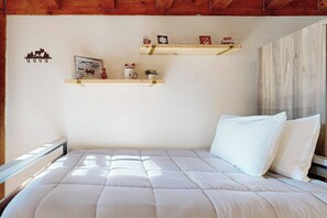 A bedroom with a bed, a wooden ceiling, and two shelves with decorative items. - Riverbend Ski Retreat - Modern Condo minutes to Sunday River, Breweries & Bethel (Bethel)