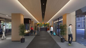 A modern hotel lobby with a central reception desk, seating areas, and a fire feature. - Hotel101 Niseko (Abuta District)