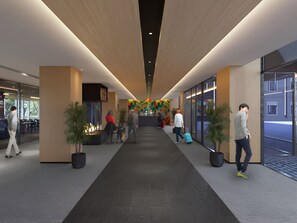 Eine moderne Hotelhalle mit einer zentralen Rezeption, Sitzbereichen und einem Kamin.