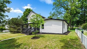 A single-story house with a front porch and a small tree in the yard. - The Howder House / Refined 1BR  / Sleeps 4 (Hillsdale)