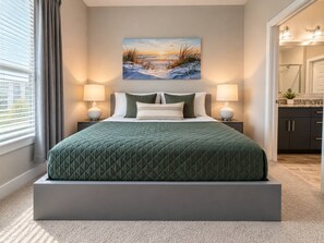 A modern bedroom with a large bed, a painting above the bed, and a view of a bathroom. - Big Home 3 Beds Balcony Pool View Gym Downtown Jax (Jacksonville)