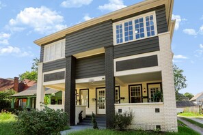 A two-story house with a front porch, a visible staircase, and a brick chimney. - Cozy Herron-Morton Getaway Near Downtown (Indianapolis)