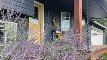 A house with a porch, a door, and a window.