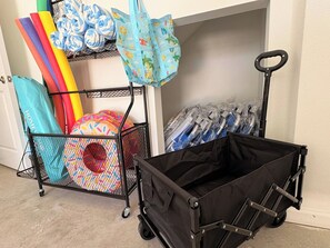 A storage cart with a black cover and a mesh cart with colorful items. - Pool | Jacuzzi | NO EXTRA FEE 5 min to beach (Palm Coast)