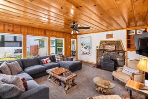 A cozy living room with a fireplace, a sofa set, a coffee table, and a television. - Walk to the Lake | Hot Tub & Game Loft (South Lake Tahoe)