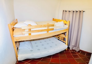A bunk bed with a lower bunk and a mattress with a floral pattern.