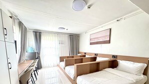 A hotel room with a large bed, a desk, and a chair. - Royal Oceancrest Panglao 1 (Dauis)