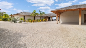 A resort with multiple buildings, covered outdoor seating areas, and a gravel courtyard. - Kas Amare (Kralendijk)