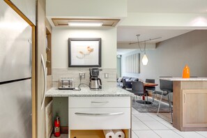 A modern kitchen with a built-in toaster, coffee maker, and a framed artwork on the wall. -  Tampa vacation rental, located just one block from Bayshore Boulevard! (Tampa)