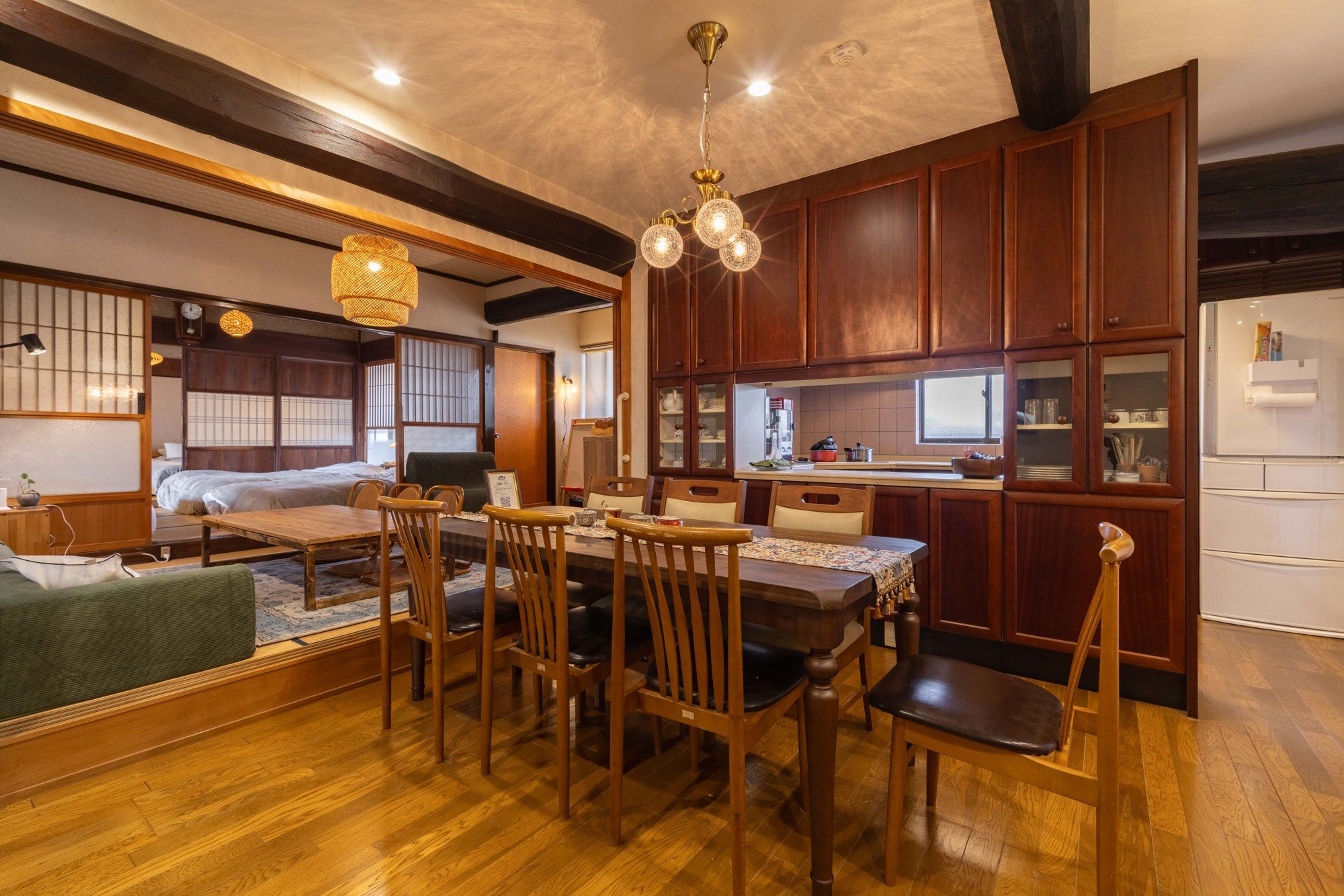 A traditional Japanese-style room with tatami flooring, a low table with chairs, and a sliding shoji screen door.
