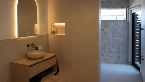 A modern bathroom with a large mirror, a round sink, and a shower area. - Infrared sauna, outdoor bath, close to town and mountain bike trails (Kaikōura)