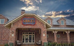 A brick building with a sign reading 'GRACE'S' above the entrance. - Relax & Recharge  in this Spacious Apartment / near the Medical Center & NRG! (Houston)