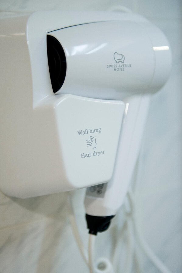 A wall-mounted hair dryer with the text 'Wall hung Hair dryer' and 'SWISS AVENUE HOTEL' visible.