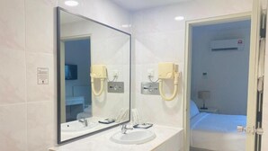A modern bathroom with a large mirror, two sinks, and a shower area. - SWISS AVENUE HOTEL SUNGAI PETANI  (Sungai Petani)