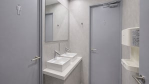 A modern bathroom with two sinks, a mirror, and a toilet. - ATO Hotel Kyoto (Kyoto)