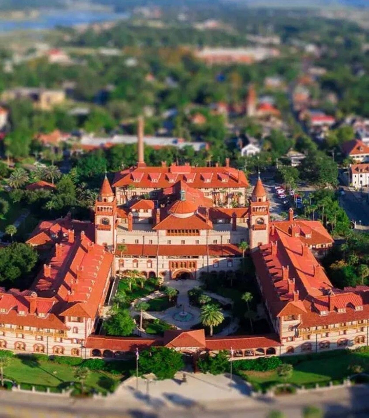 A large, historic building with multiple towers and a central courtyard.