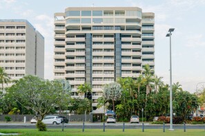 A multi-story hotel with a modern design, featuring balconies and a central glass facade. - Rydges 92B | 9th Floor City & Esplanade Views (Cairns North)