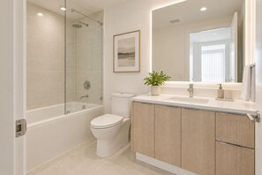 Un baño moderno con bañera, inodoro y zona de lavamanos.