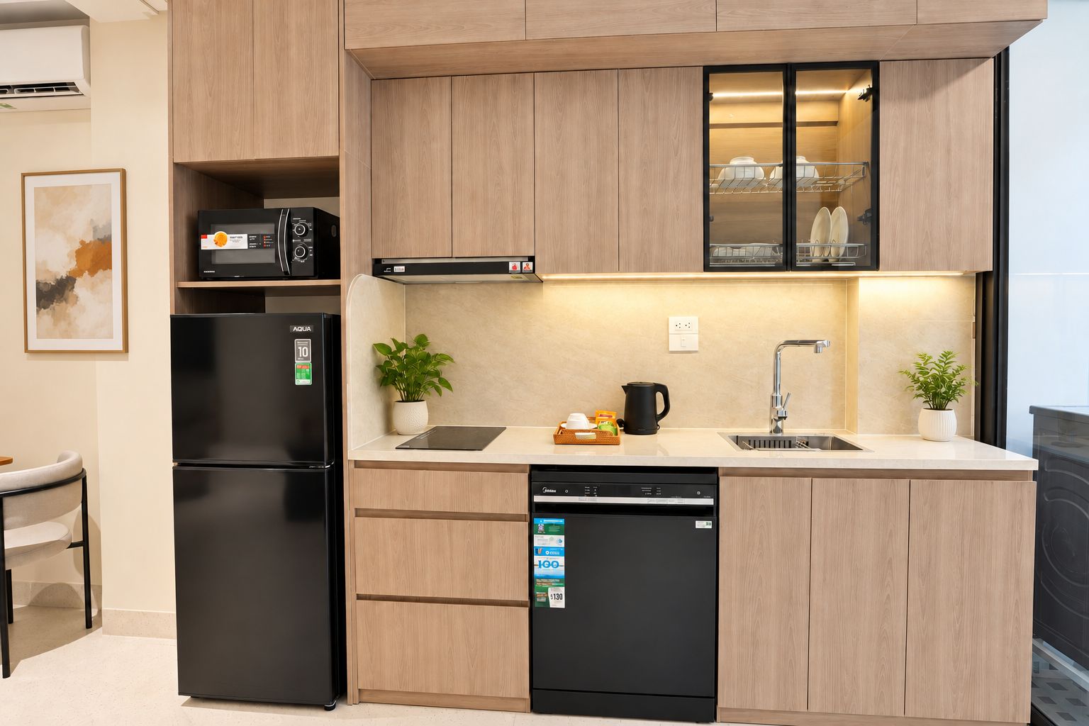 A modern kitchen with a refrigerator, dishwasher, microwave, and a sink with a faucet.