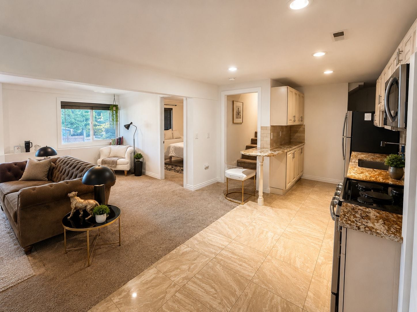 A modern apartment with a living room, a kitchen, and a bedroom.