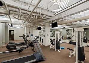 A gym with treadmills, weight machines, and exercise equipment.