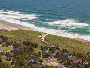 A coastal residential area with houses, a beach, and a boardwalk leading to the shore. - The Little Mermaid - Dogs OK - Minutes to beach (Pacific City)