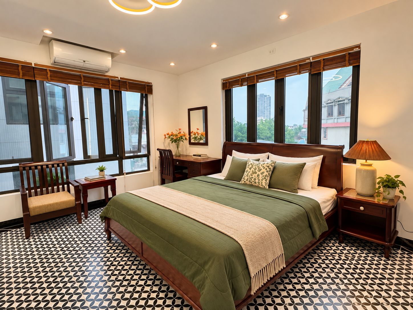 A hotel room with a large bed, a desk, a chair, and a window with a city view.