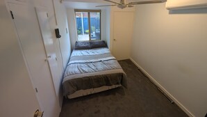A bedroom with a bed, a ceiling fan, a window, and a door. - 2 bed 1 bath house in the heart of Bayswater! (Bayswater)