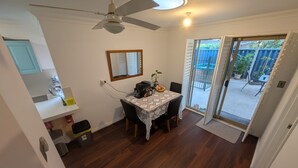 A dining area with a table, chairs, a ceiling fan, and a view of the backyard through a sliding glass door. - 2 bed 1 bath house in the heart of Bayswater! (Bayswater)