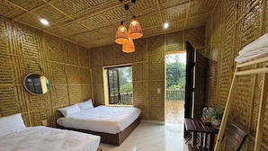 A room with two beds, a TV, and a table with chairs. - Suoi Sapa Homestay And Trekking (Ta Van)