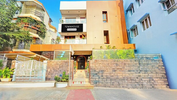 A modern townhouse with a sign indicating it is company-serviced. - Townhouse Seethammadhara Junction (Visakhapatnam)