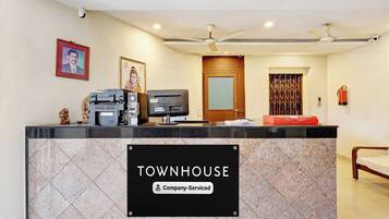 A reception desk with a sign reading 'TOWNHOUSE Company-Serviced'.
