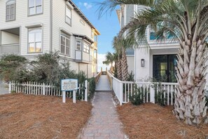 A pathway leading to a building with a sign indicating beach rules. - Private Beach Access And Pool/Amazing Gulf Views (Santa Rosa Beach)