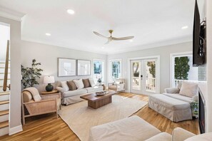 A spacious living room with a sofa, armchairs, a coffee table, and a ceiling fan. - Private Beach Access And Pool/Amazing Gulf Views (Santa Rosa Beach)
