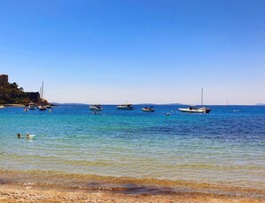 A coastal scene with boats on calm waters and a clear sky. - Tranquil Mediterranean Oasis in Croatia (Hyères)