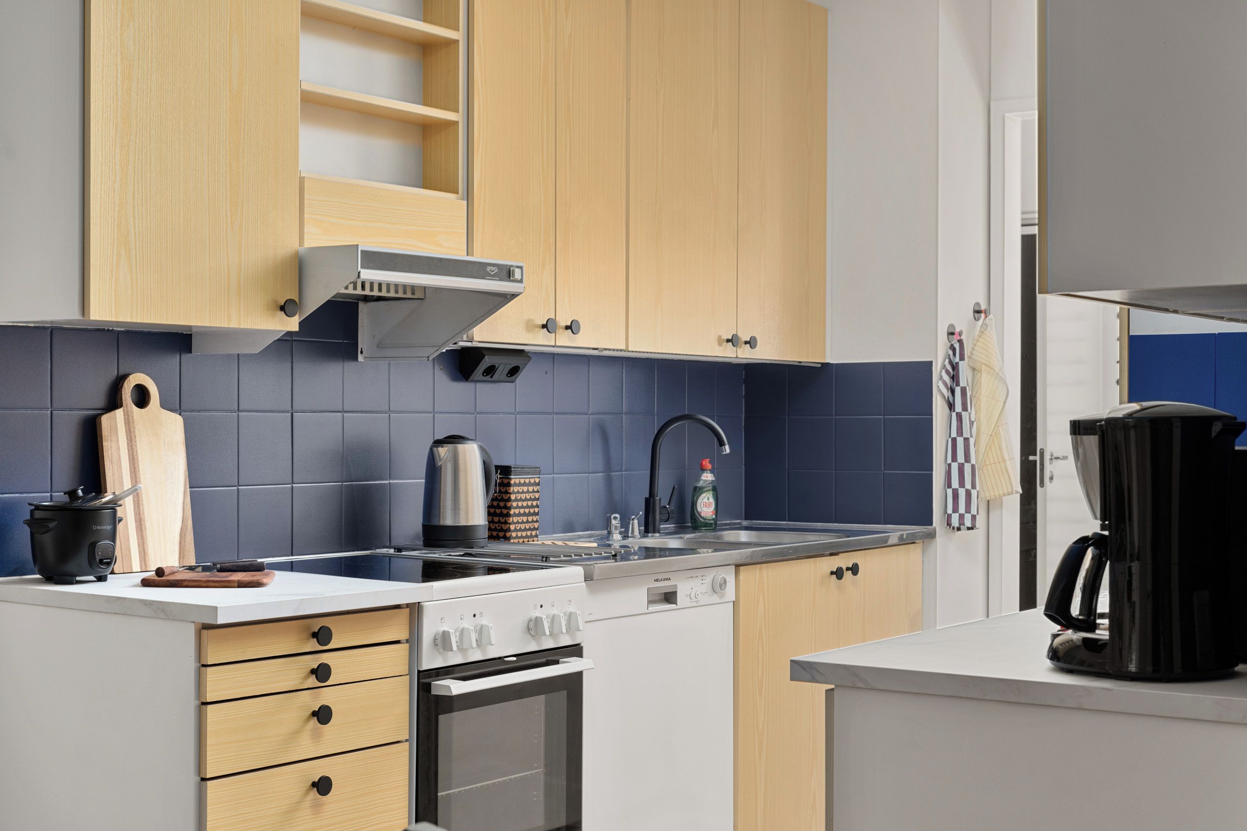A modern kitchen with a stove, oven, and sink.