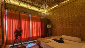 A room with a bed, a desk, a chair, a lamp, and a window with curtains. - Sailor Eco Resort. Saint Martin (Chittagong Division)