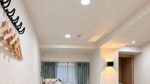 A neatly arranged bedroom with a bed, a desk, and a chair. - Hub82 (Seoul)