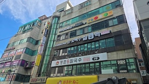 A multi-story building with various commercial establishments, including a casual pub and a restaurant.