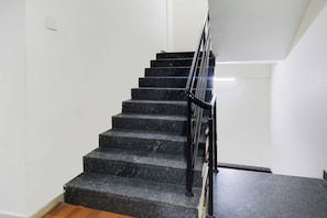 A staircase with black steps and a metal railing. - Townhouse Oak Shilparamam Art (Hyderabad)
