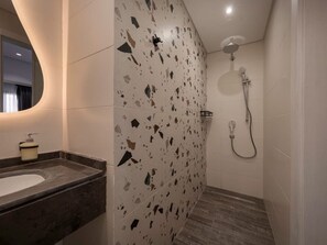 A bathroom with a sink, mirror, shower, and terrazzo flooring. - Lovely Home at 22 by Spacey #48 (cairo)