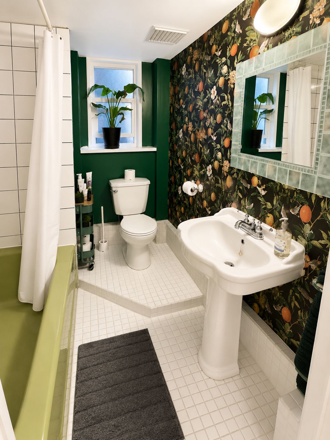 A bathroom with a toilet, sink, and shower area.