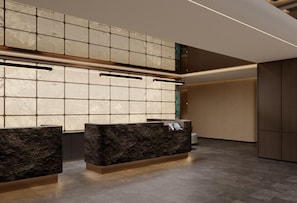 A reception area with a marble reception desk, a tiled wall, and a high ceiling. - Dequan P-R International Hotel (Beijing)