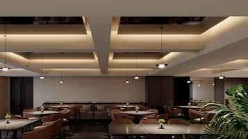 A modern dining area with tables and chairs, pendant lighting, and a large plant in the foreground.