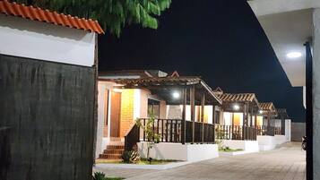 A row of residential buildings with a covered outdoor area, possibly a courtyard, and a paved walkway.