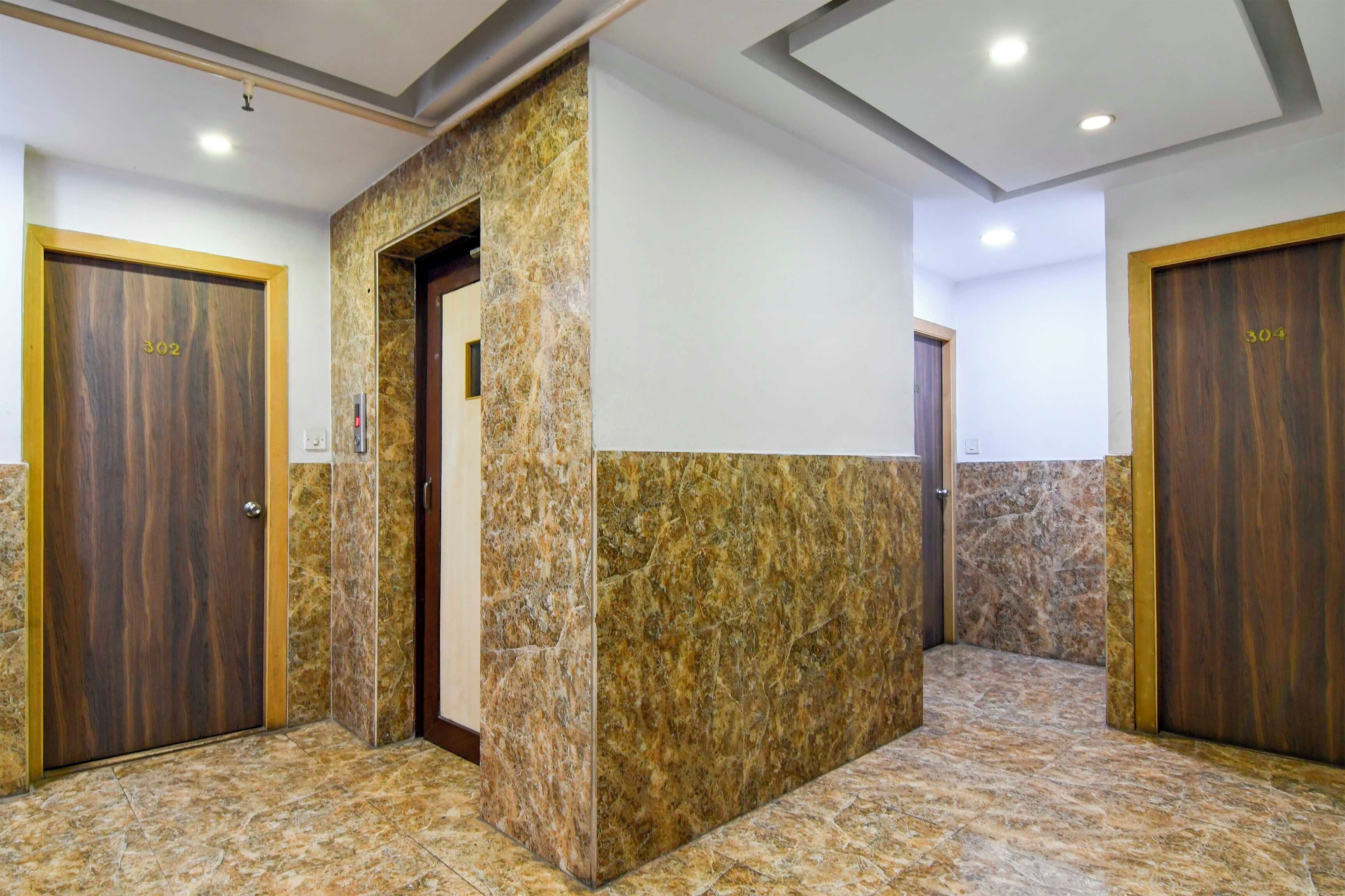 A hallway with two wooden doors, each marked with a number.