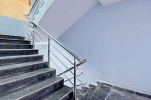 A staircase with metal handrails and dark steps. - Townhouse Oak Nizampet X Bus Terminal (Hyderabad)