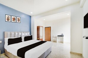A hotel room with a bed, a desk, and a chair. - Townhouse Nagole Metro Station (Hyderabad)